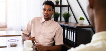 side-view-men-chatting-work (2)